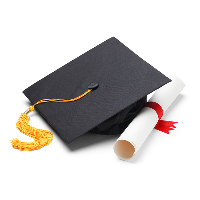Black graduation cap with a yellow tassel next to a rolled up diploma with a red ribbon around it.